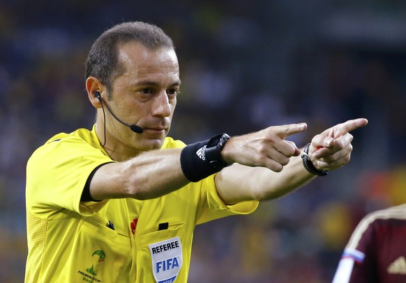 Referee Cuneyt Cakir of Turkey gestures during the 2014 World Cup Group H soccer match between Russia and Algeria at the Baixada arena in Curitiba June 26, 2014. REUTERS/Murad Sezer (BRAZIL - Tags: SO ...