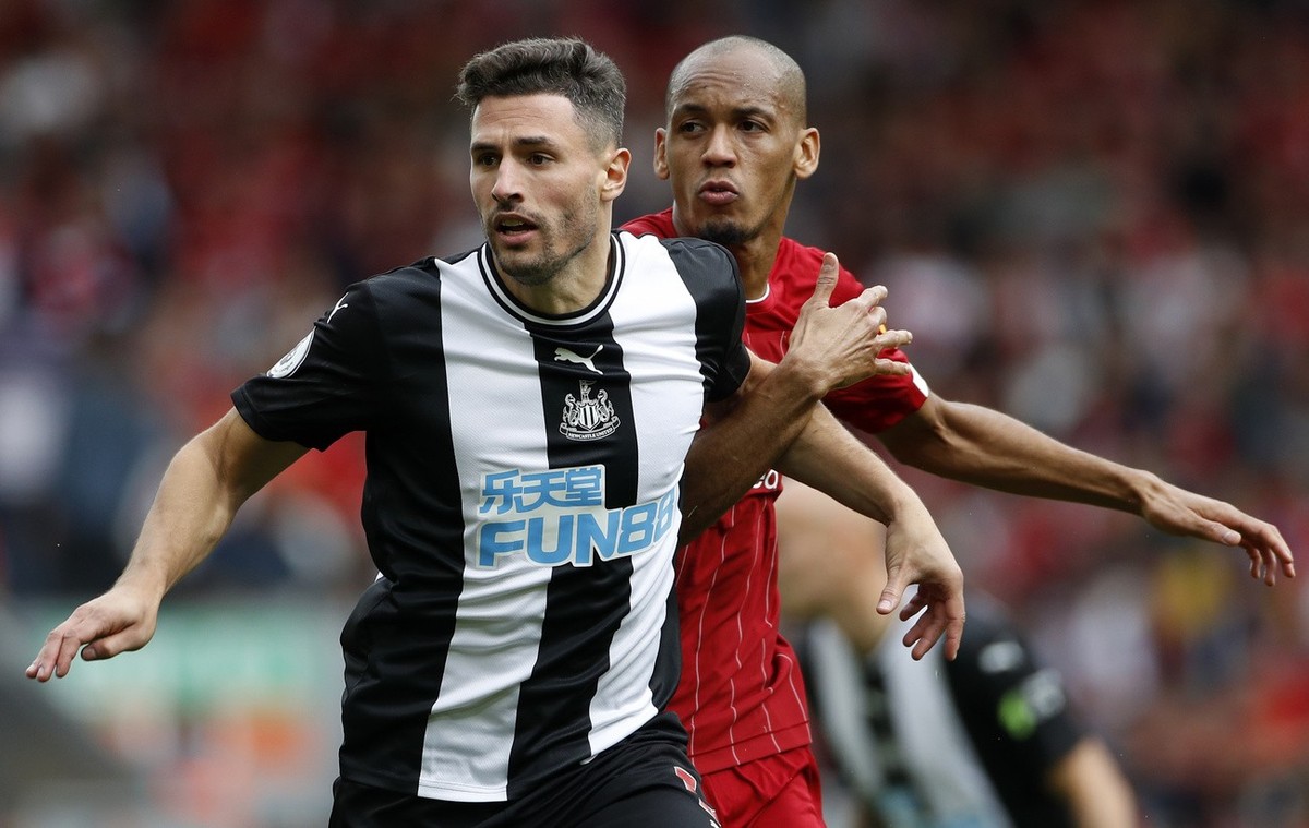 Liverpool's Fabinho, right, challenges Newcastle's Fabian Schar during the English Premier League soccer match between Liverpool and Newcastle at Anfield stadium in Liverpool, England, Satur ...