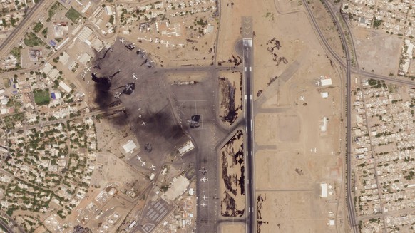 This satellite photo from Planet Labs PBC shows damaged aircraft, including one on fire, at Khartoum International Airport in Khartoum, Sudan, Monday, April 17, 2023. Satellite images from Planet Labs ...