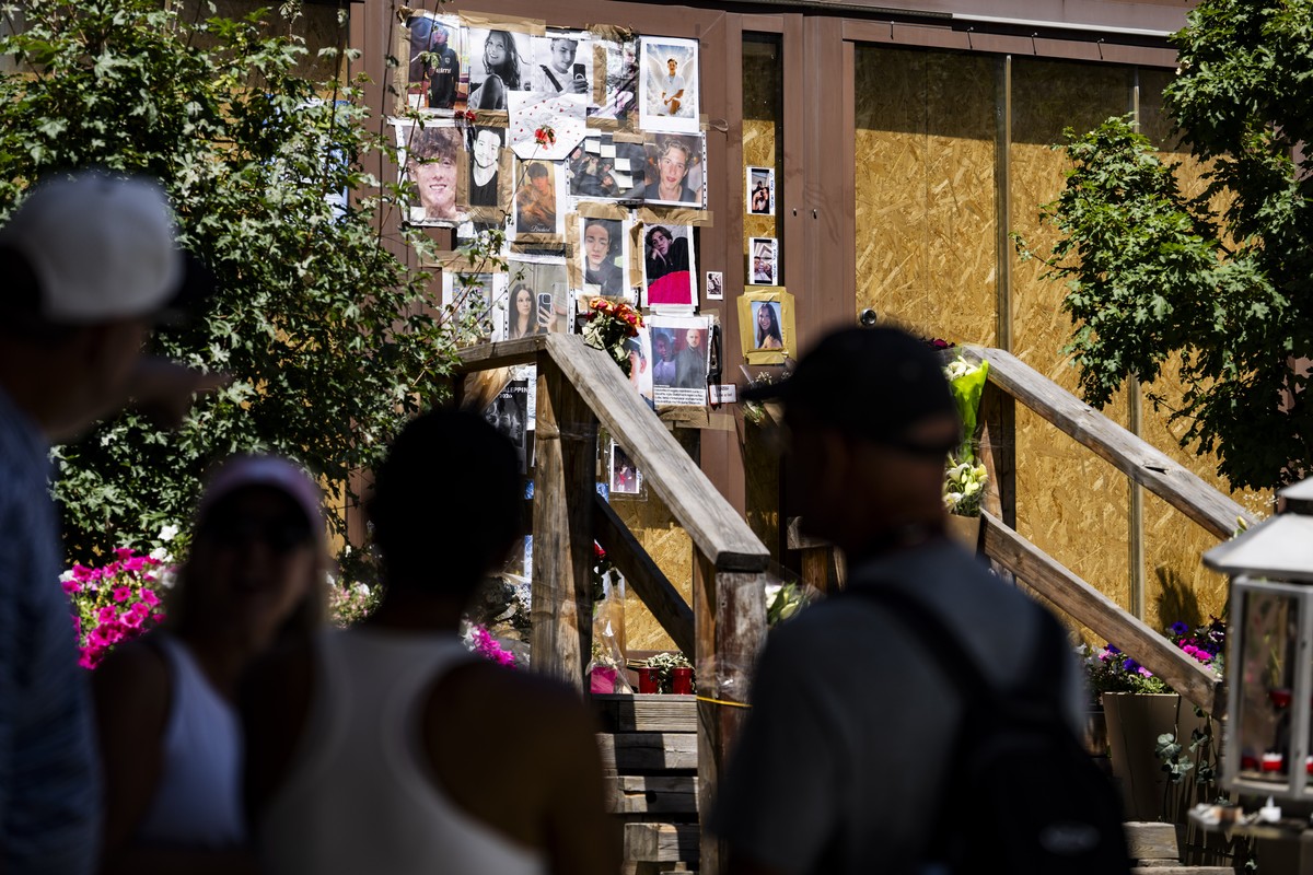 epa13100252 Portraits of the young victims are displayed at the entrance of the bar Le Constellation six months after a deadly fire, in Crans-Montana, Switzerland, 09 July 2026. Forty-one people, most ...
