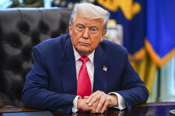 epa12300754 US President Donald Trump looks on during an event marking the 90th anniversary of the Social Security Act, in the Oval Office at the White House, Washington, DC, USA, 14 August 2025. Pres ...