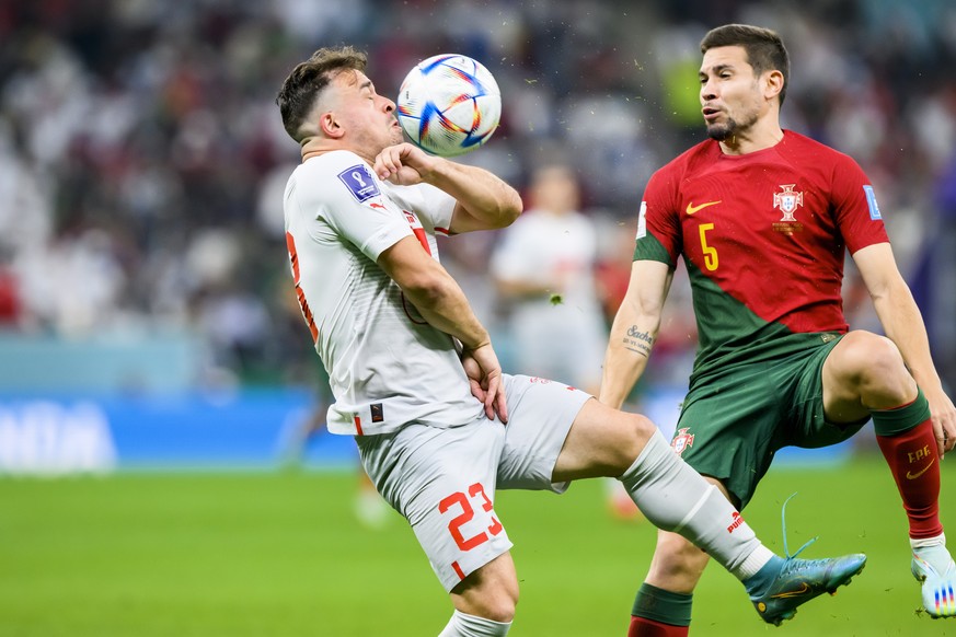 epa10352905 Switzerland's Xherdan Shaqiri (L) in action against Portugal's Raphael Guerreiro during the FIFA World Cup 2022 round of 16 soccer match between Portugal and Switzerland at Lusail Stadium  ...