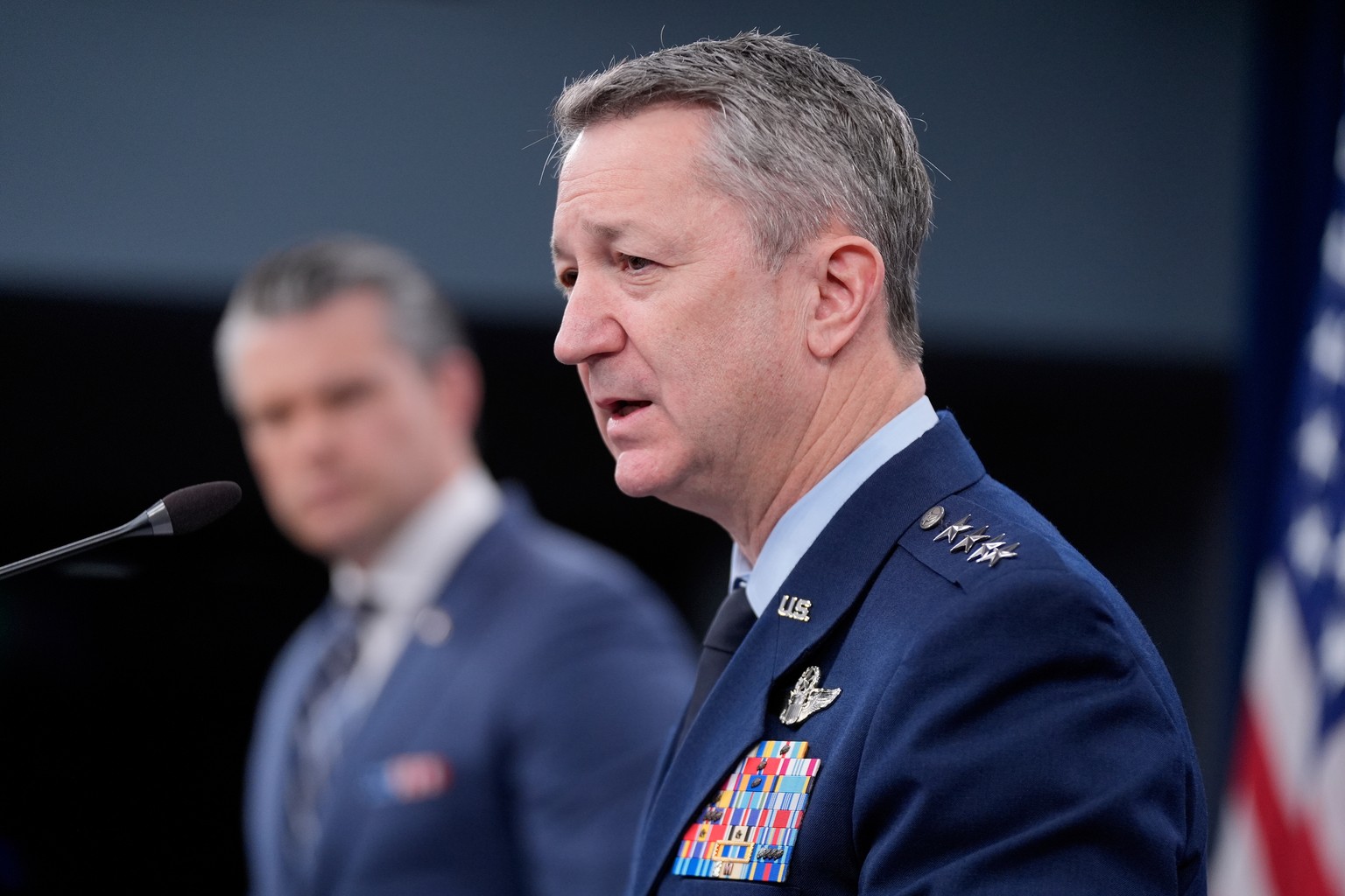 Defense Secretary Pete Hegseth and Chairman of the Joint Chiefs of Staff Gen. Dan Caine speak to members of the media during a press briefing at the Pentagon in Washington, Thursday, March 19, 2026. ( ...