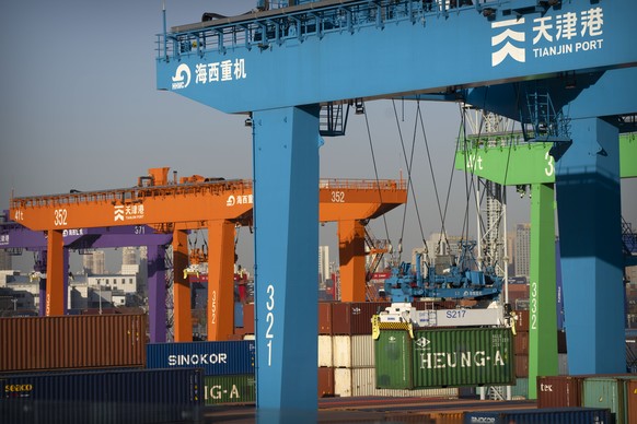 A crane lifts a shipping container at an automated container port in Tianjin, China, Monday, Jan. 16, 2023. China&#039;s economic growth fell to 3% last year under pressure from antivirus controls and ...