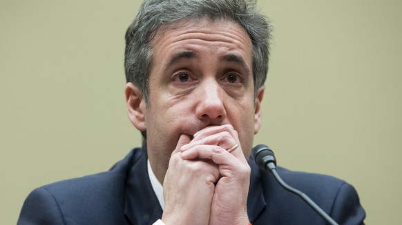 epa07402694 Michael Cohen, former attorney to US President Donald J. Trump, reacts while listening to the closing remarks of House Oversight and Reform Committee Chairman Elijah Cummings, while appear ...