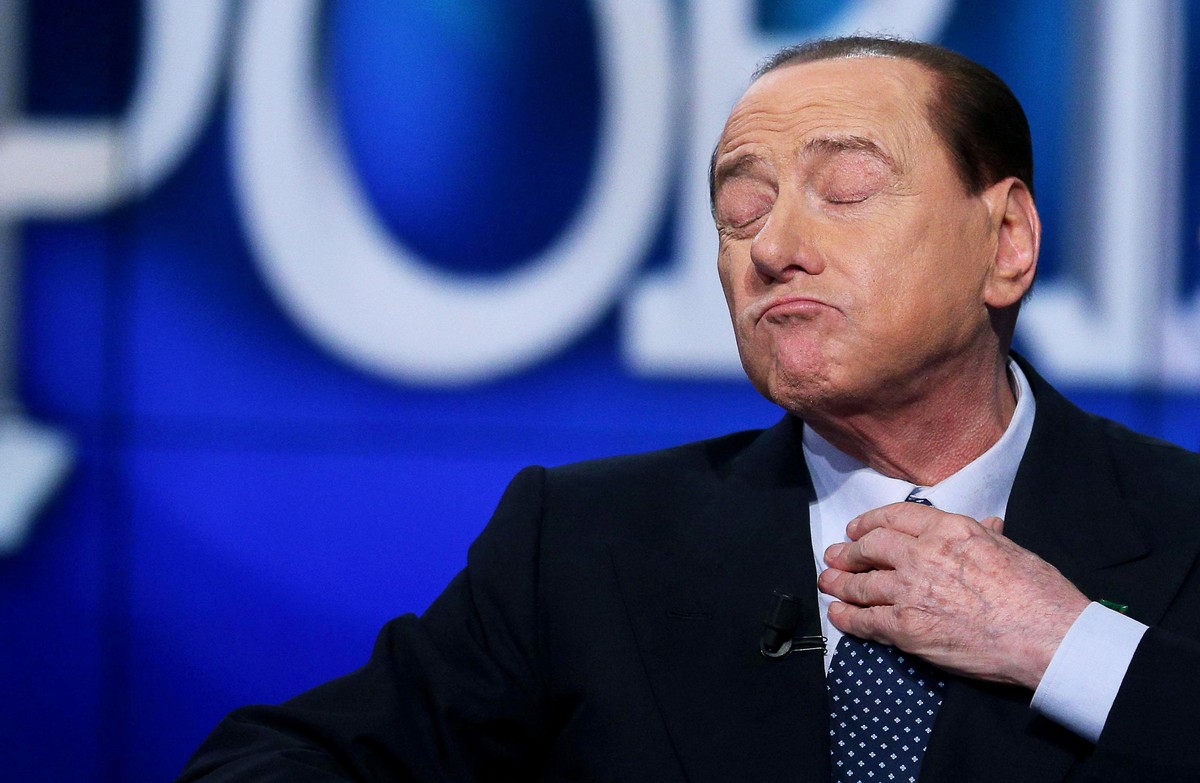 epa09093316 (FILE) Former Italian prime minister Silvio Berlusconi adjusting his tie as he appears on 'Porta a Porta' TV show on Rai 1 in Rome, Italy, 21 May 2014 (reissued 24 March 2021). F ...