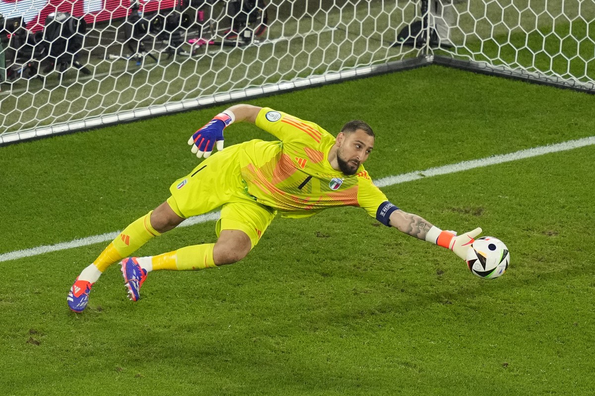Italy's goalkeeper Gianluigi Donnarumma deflects a shot by Spain's Alvaro Morata for Italy's Riccardo Calafiori to score an own goal during a Group B match between Spain and Italy at th ...