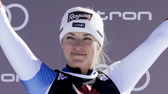 Switzerland&#039;s Lara Gut Behrami celebrates on the podium after after placing third at an alpine ski, women&#039;s World Cup super-G, in Lenzerheide, Switzerland, Saturday, March 5, 2022. (AP Photo ...