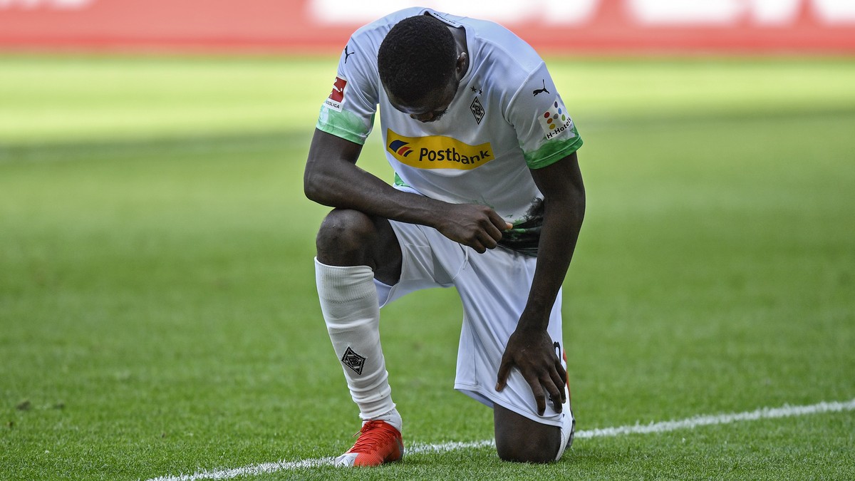 Moenchengladbach's Marcus Thuram taking the knee after scoring his side's second goal during the German Bundesliga soccer match between Borussia Moenchengladbach and Union Berlin in Moenchen ...