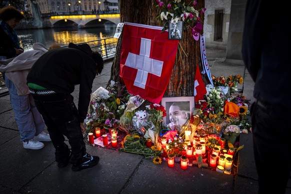 People light candles in front of the makeshift memorial for Muriel Furrer from Switzerland, who died after a cycling crash during the 2024 UCI Road and Paracycling Road World Championships in Zurich,  ...