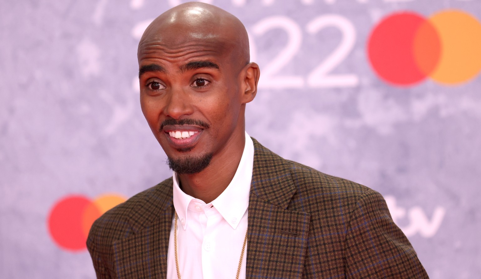 epa09739236 Mo Farah arrives for the 42nd Brit Awards ceremony at The O2 Arena in London, Britain, 08 February 2022. The annual pop music awards are presented by the British Phonographic Industry (BPI ...
