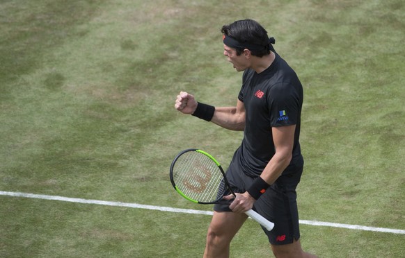 Milos Raonic celebrates after he beats Lucas Pouille in their semifinal tennis match during the ATP Mercedes Cup in Stuttgart, Saturday June 16, 2018. (Marijan Murat/dpa via AP)