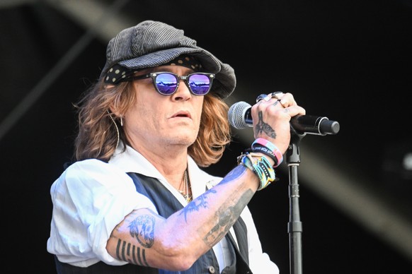 epa10022752 US actor Johnny Depp performs on stage at the Helsinki Blues Festival, Finland, 19 June 2022. EPA/KIMMO BRANDT
