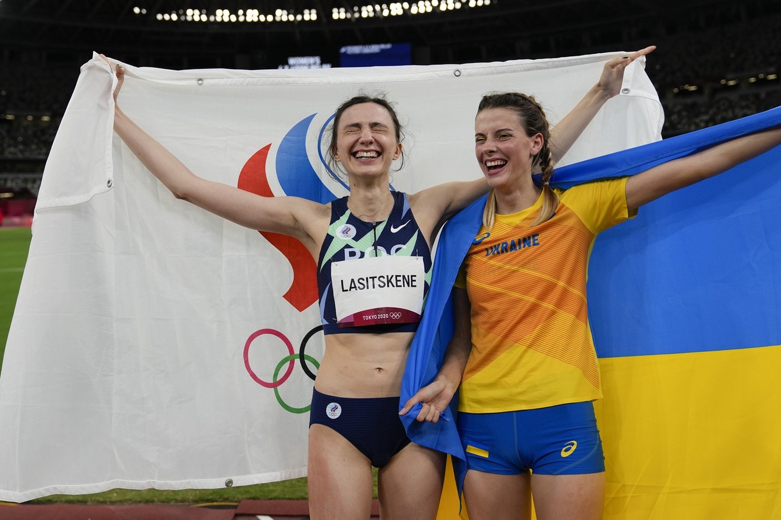 Mariya Lasitskene, left, of the Russian Olympic Committee, celebrates after winning the gold medal in the women&#039;s high jump final with bronze medalist Yaroslava Mahuchikh, of Ukraine, at the 2020 ...
