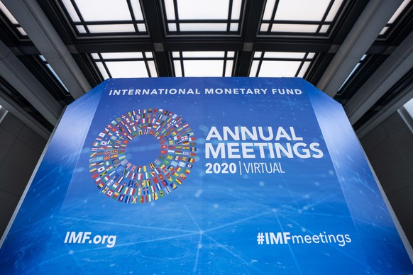 epa08743973 Signs for the International Monetary Fund (IMF) World Bank Group 2020 annual fall meeting, which has gone virtual due to the Coronavirus pandemic, outside IMF headquarters in Washington, D ...