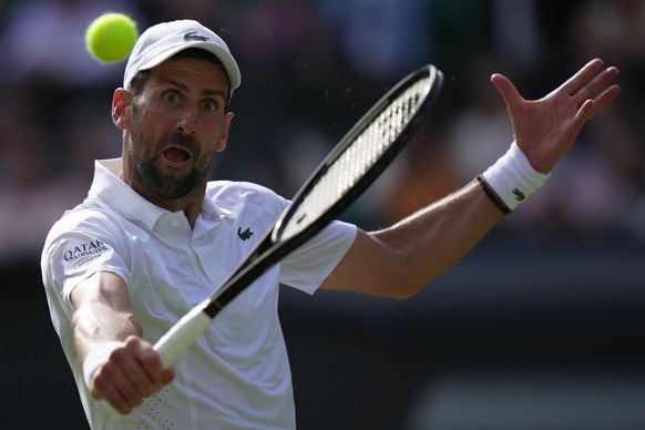 Novak Djokovic of Serbia returns the ball to Roman Saffiullin of Russia in their fourth round men's singles match at the Wimbledon Tennis Championships in London, Sunday, July 5, 2026. (AP Photo/ ...
