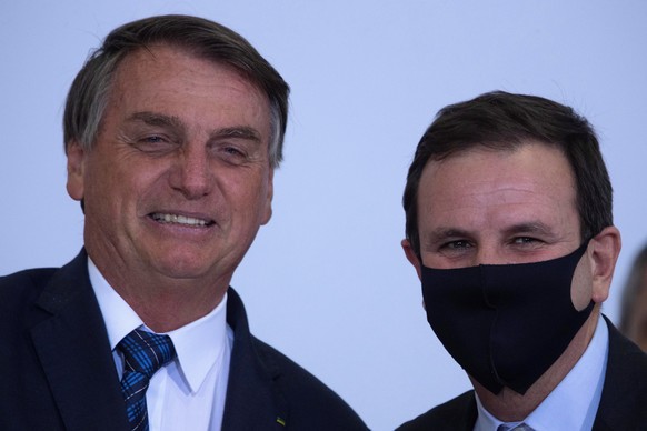 epa09032739 President of Brazil, Jair Bolsonaro (L), and the mayor of the city of Rio de Janeiro, Eduardo Paes, participate in the launch of the Mayor+Brazil Agenda, at the Planalto Palace, in Brasili ...