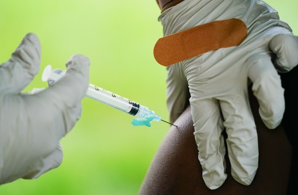 FILE - A health worker administers a dose of a Pfizer COVID-19 vaccine during a vaccination clinic in Reading, Pa., Sept. 14, 2021. Pfizer asked U.S. regulators Monday, Aug. 22, 2022, to authorize its ...