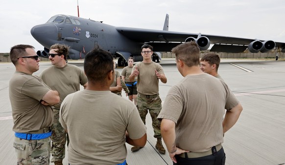 epa11492554 US Air Force personnel chat after a briefing in front of a B52 bomber of the US Air Force during a media event held at Mihail Kogalniceanu NATO air-base at the Black Sea shore, in Romania, ...
