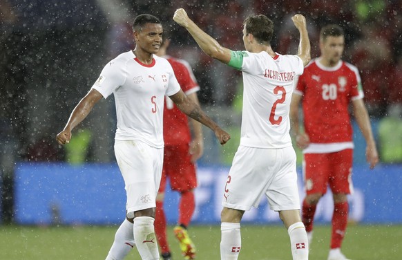 Switzerland&#039;s Manuel Akanji, left, and Switzerland&#039;s Stephan Lichtsteiner celebrate their victory during the group E match between Switzerland and Serbia at the 2018 soccer World Cup in the  ...