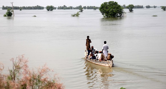 epa10147380 People affected by floods move to higher grounds in Dadu district, Sindh province, Pakistan, 30 August 2022. According to the National Disaster Management Authority (NDMA) on 27 August, fl ...