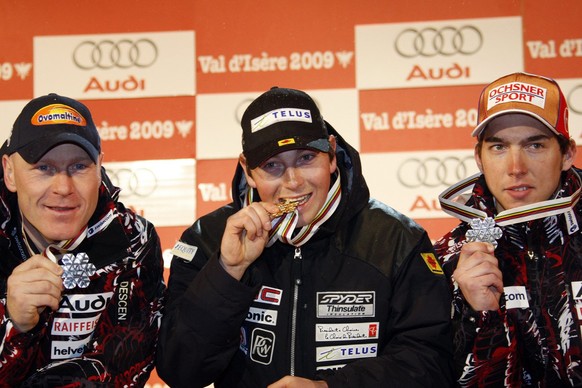 From left: Didier Cuche from Switzerland shows his silver medal, John Kucera from Canada shows his gold medal and Carlo Janka from Switzerland shows his bronze medal during the medal ceremony at the W ...