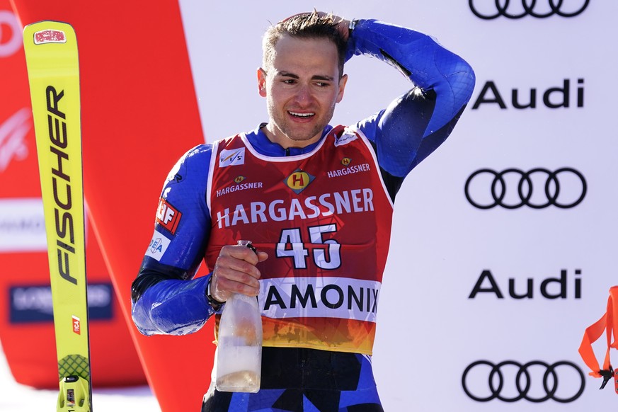 Greece&#039;s Aj Ginnis celebrates on the podium after taking second place in an alpine ski, men&#039;s World Cup slalom in Chamonix, France, Saturday, Feb. 4, 2023. (AP Photo/Pier Marco Tacca)