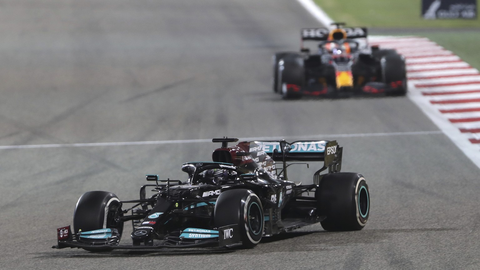 Mercedes driver Lewis Hamilton of Britain steers his car followed by Red Bull driver Max Verstappen of the Netherlands during the Bahrain Formula One Grand Prix at the Bahrain International Circuit in ...