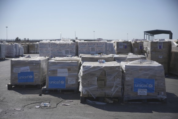 Piles of humanitarian aid packages from UNICEF wait to be picked up on the Palestinian side of the Kerem Shalom crossing in the Gaza Strip, Thursday, July 24, 2025. during a media tour organized by th ...