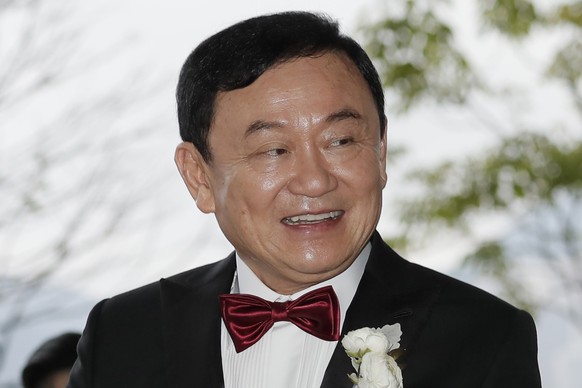 FILE - Former Thai Prime Minister Thaksin Shinawatra welcomes his guests for the wedding of his youngest daughter Paetongtarn &quot;Ing&quot; Shinawatra at a hotel in Hong Kong on March 22, 2019. Thak ...