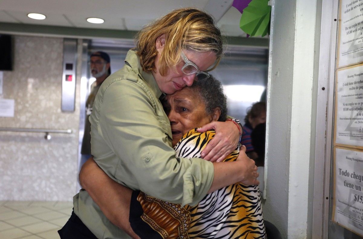 epa06220942 San Juan's Mayor Carmen Yulin Cruz (L) hugs a woman during her visit to an elderly home in San Juan, Puerto Rico, 22 September 2017. Puerto Rico prepares to rebuild the island which i ...