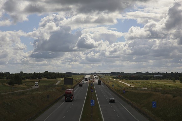 Cars drive on express road in Suwalki, Poland, Thursday, July 7, 2022. The Suwalki gap, which stretches about 100 kilometres along the Lithuanian-Polish border and lies sandwiched between Belarus and  ...