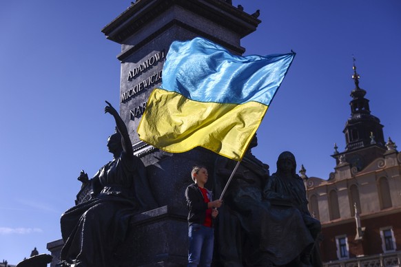 Solidarity With Ukraine Protest In Poland After Russian Missile Assault A boy holds Ukrainian flag during a demonstration of solidarity with Ukraine at the Main Square, after latest Russian missiles t ...