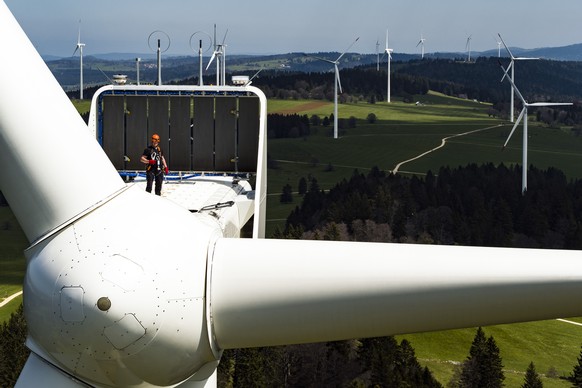 Pierre Berger, JUVENT employee in charge of security and maintenance stand on a wind turbine of 150m overall height at the JUVENT power plant on the Mont-Soleil in Saint-Imier, Switzerland on Wednesda ...