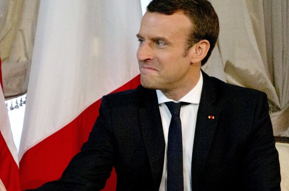 epa05989023 US President Donald J. Trump shakes hands with French President Emmanuel Macron (R) during a meeting on the sidelines of the NATO (North Atlantic Treaty Organization) summit, at the US amb ...