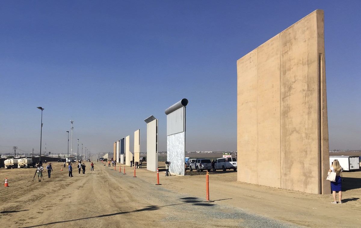 People look at prototypes of a border wall Thursday, Oct. 26, 2017, in San Diego. Contractors have completed eight prototypes of President Donald Trump's proposed border wall with Mexico, trigger ...