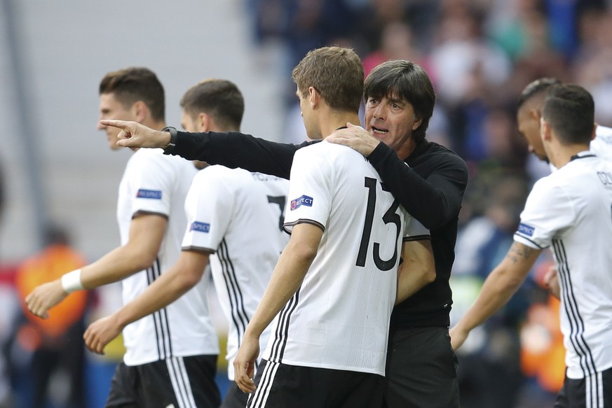 Germany coach Joachim Loew talks to Germany&#039;s Thomas Mueller during the Euro 2016 round of 16 soccer match between Germany and Slovakia, at the Pierre Mauroy stadium in Villeneuve d&#039;Ascq, ne ...