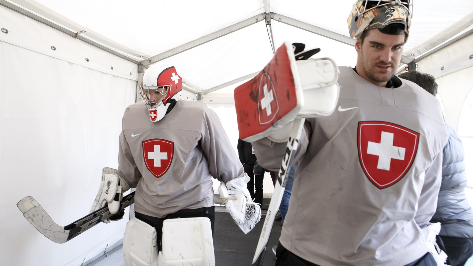 Switzerland&#039;s goaltender Leonardo Genoni, left, and Switzerland&#039;s goaltender Reto Berra, return to cloakroom, after a training session of the IIHF 2018 World Championship at the practice are ...