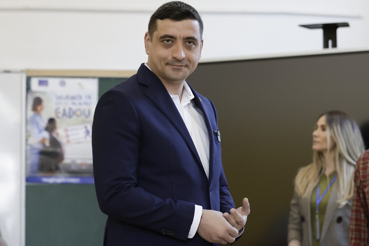 epa12072424 Presidential candidate and far-right party Alliance for the Union of Romanians (AUR) leader George Simion reacts after voting in the first round of presidential elections at a polling stat ...