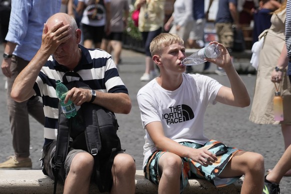 Tourists refresh themselves with water in Rome, Saturday, July 8, 2023. An intense heat wave has reached Italy, bringing temperatures close to 40 degrees Celsius in many cities across the country. (AP ...
