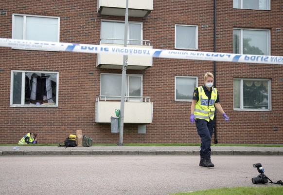epa05506798 Swedish police investigates the area where an apartment was demolished in an explosion overnight, in the Biskopsgarden in Gothenburg, south of Sweden, 22 August 2016. Reportedly a child wh ...