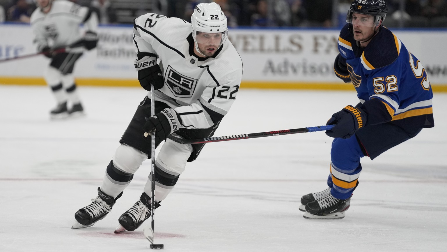 Los Angeles Kings' Kevin Fiala (22) handles the puck as St. Louis Blues' Noel Acciari (52) defends during the first period of an NHL hockey game Monday, Oct. 31, 2022, in St. Louis. (AP Photo/Jeff Rob ...