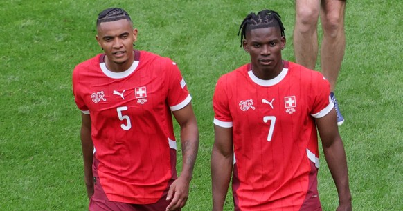 epa11412450 Manuel Akanji (L) and Breel Embolo (R) of Switzerland celebrate after winning the UEFA EURO 2024 group A match between Hungary and Switzerland in Cologne, Germany, 15 June 2024. EPA/OLIVIE ...