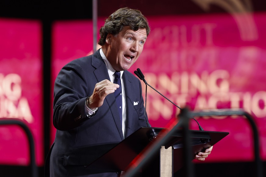 epa12397012 US media personality Tucker Carlson speaks during the public memorial service of political activist Charlie Kirk at State Farm Stadium in Glendale, Arizona, USA, 21 September 2025. Kirk wa ...