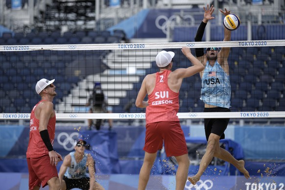 Jacob Gibb, right, of the shot of of the United States, goes up for the block of Mirco Gerson, of Switzerland, while teammates Adrian Heidrich, second from left, and Tri Bourne, second from left, look ...