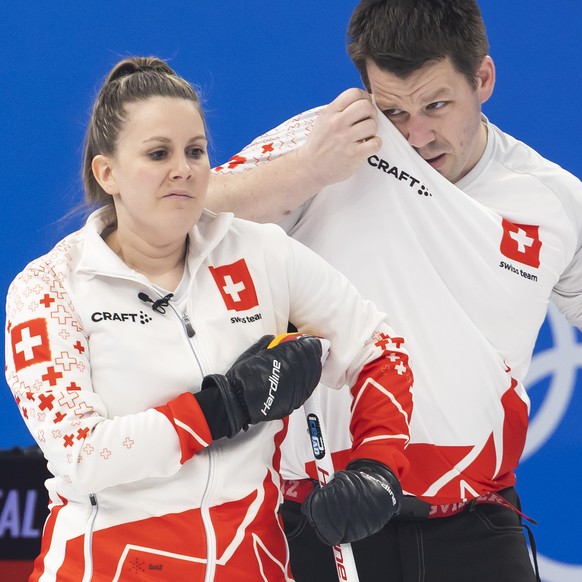 Jenny Perret, left, and Martin Rios of Switzerland team react during the curling mixed doubles preliminary round game between Czech Republic and Switzerland at the 2022 Olympic Winter Games in Beijing ...