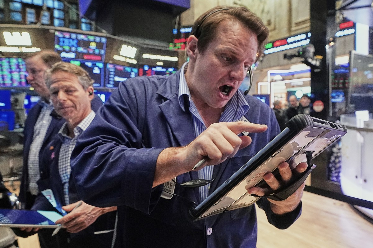 Trader Michael Milano, right, works on the floor of the New York Stock Exchange, Friday, Feb. 20, 2026. (AP Photo/Richard Drew)
Michael Milano