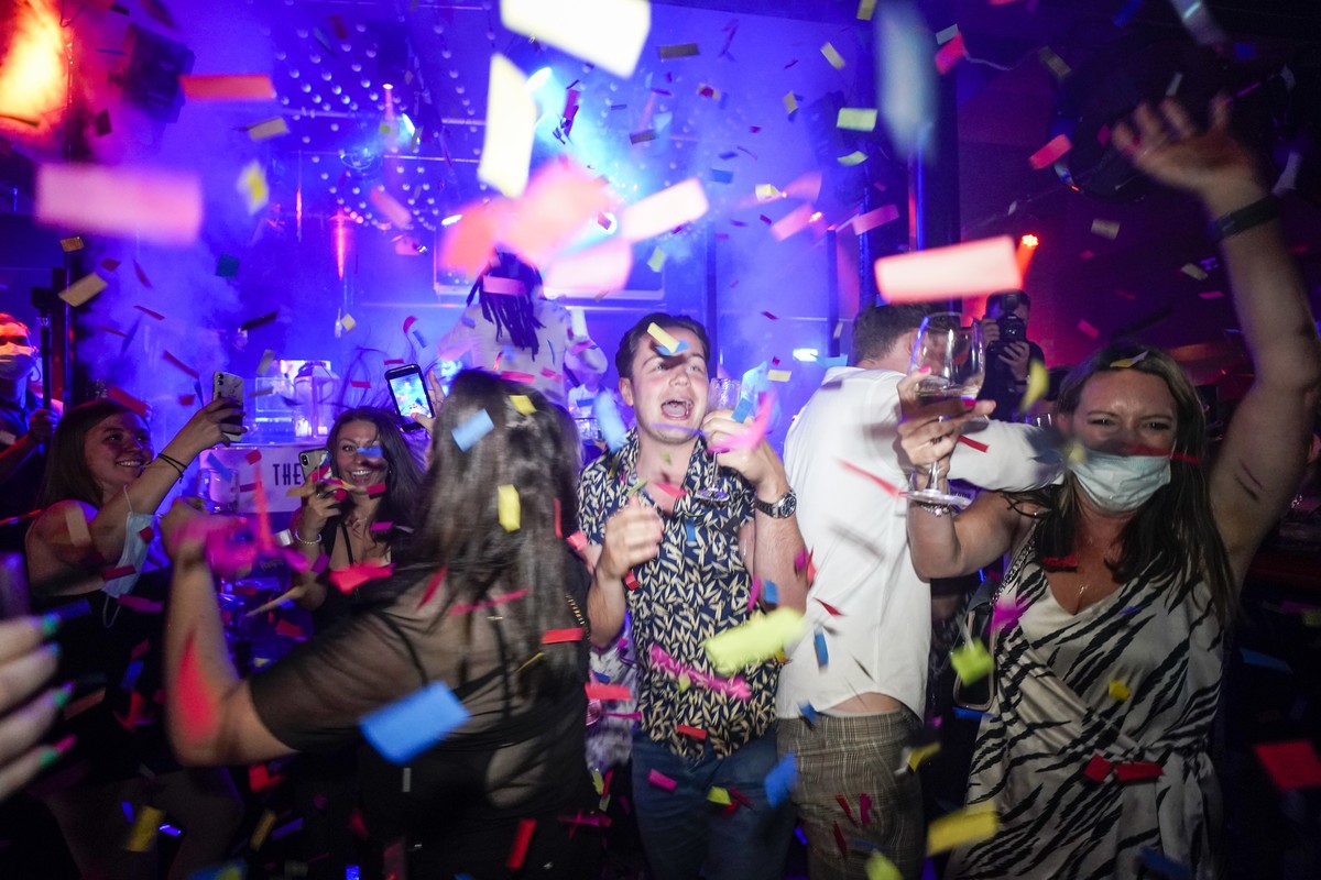 People dance shortly after the reopening, at The Piano Works in Farringdon, in London, Monday, July 19, 2021. Thousands of young people plan to dance the night away at 'Freedom Day' parties  ...