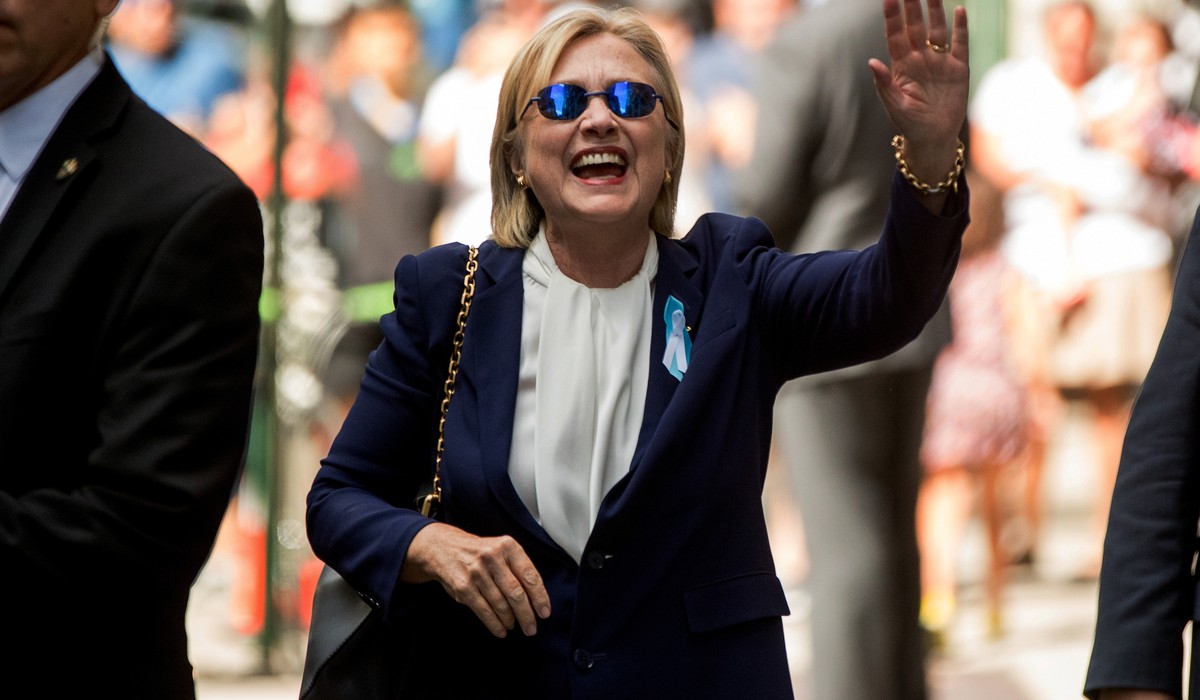 Democratic presidential candidate Hillary Clinton waves after leaving an apartment building Sunday, Sept. 11, 2016, in New York. Clinton's campaign said the Democratic presidential nominee left t ...