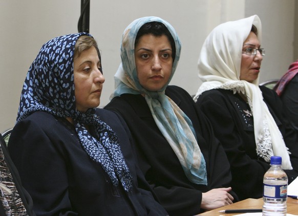 FILE - Prominent Iranian human rights activist Narges Mohammadi, center, sits next to Iranian Nobel Peace Prize laureate Shirin Ebadi, left, while attending a meeting on women&#039;s rights in Tehran, ...